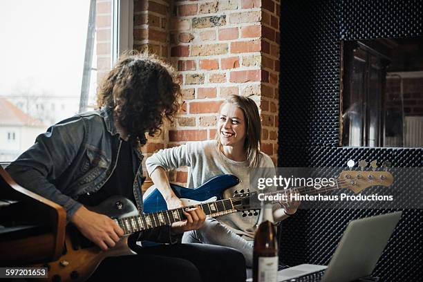 two friends playing bass and guitar in a studio - bass player bildbanksfoton och bilder