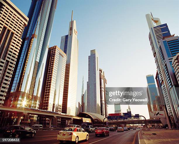 skyscrapers along sheikh zayed road at sunset - dubai financial district stock pictures, royalty-free photos & images