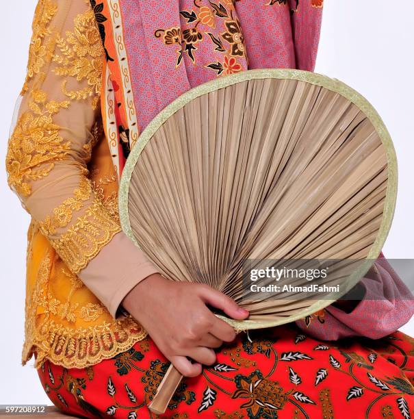model wearing colorful and bright patterns of balinese batik - malaysia batik stock pictures, royalty-free photos & images