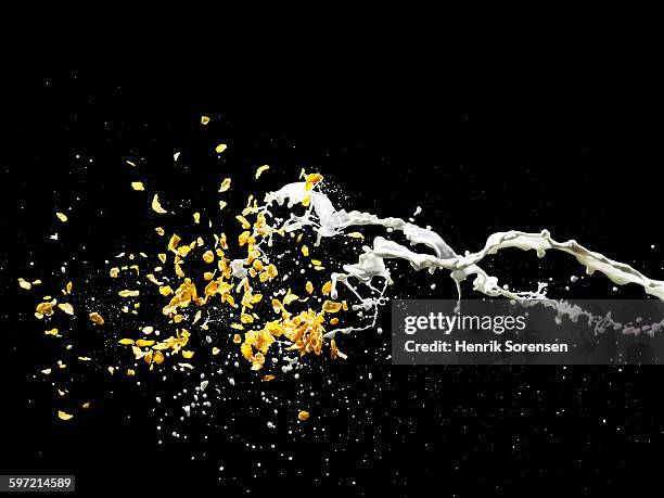 cornflakes and milk splashing in air - cornflakes stock pictures, royalty-free photos & images