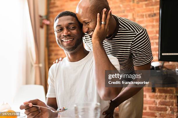 homosexual couple doing breakfast on the kitchen togetherness - gay man bildbanksfoton och bilder