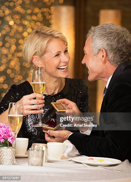 man proposing to girlfriend at dinner - fine jewelry stock pictures, royalty-free photos & images