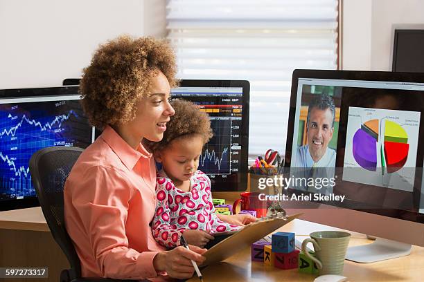 businesswoman with daughter working at home - children looking graph stock pictures, royalty-free photos & images