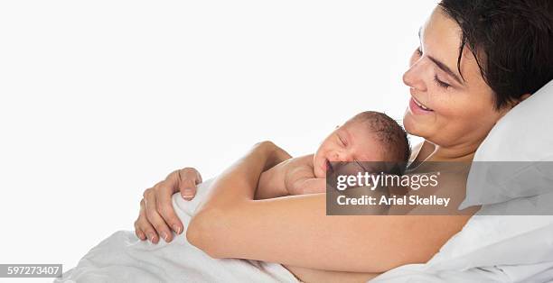 mother holding newborn infant - touching skin stock pictures, royalty-free photos & images