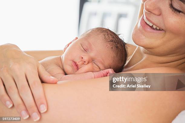 mother holding newborn infant - baby skin fotografías e imágenes de stock