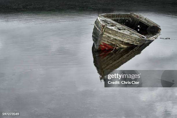 dilapidated boat in lake - sinking rowboat stock pictures, royalty-free photos & images