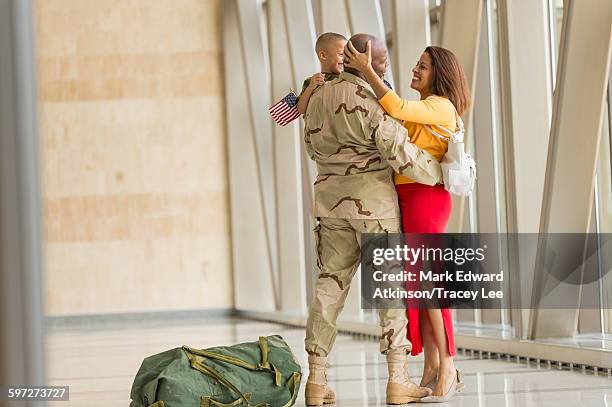 african american soldier greeting family in airport - military airfield stock pictures, royalty-free photos & images
