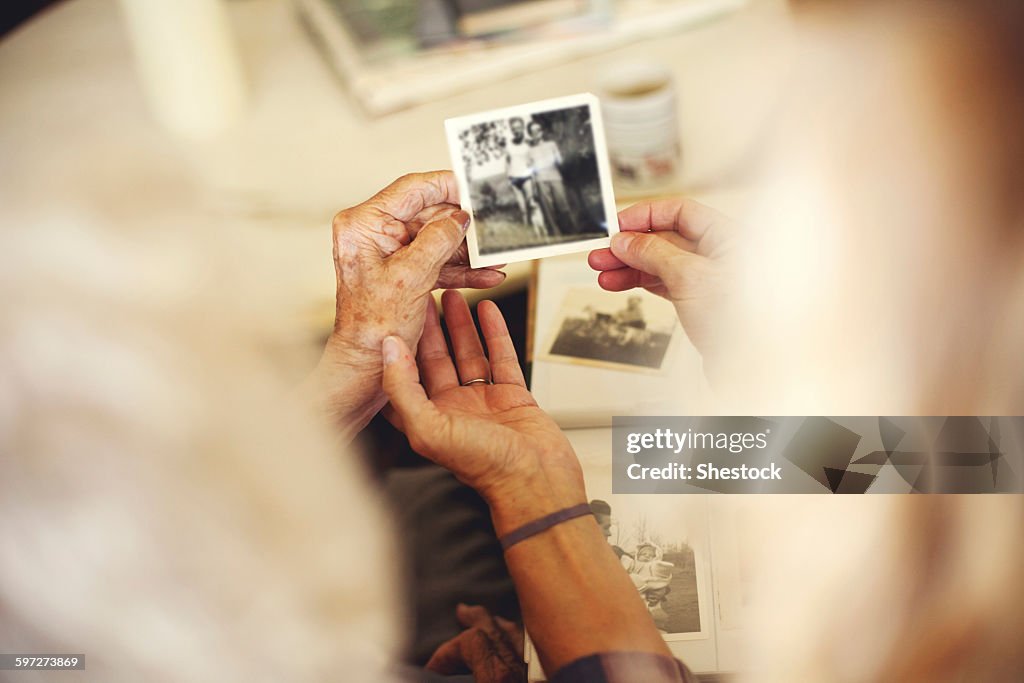 Women looking at family photographs