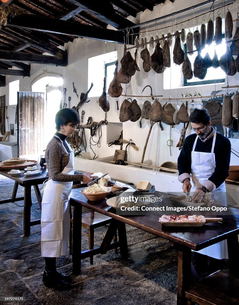 Owners preparing lunch, Agriturismo Testone, Sa Serra, Nuoro, Sardinia, Italy