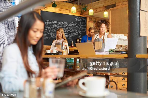 thriving coffee shop - bookie board stock pictures, royalty-free photos & images