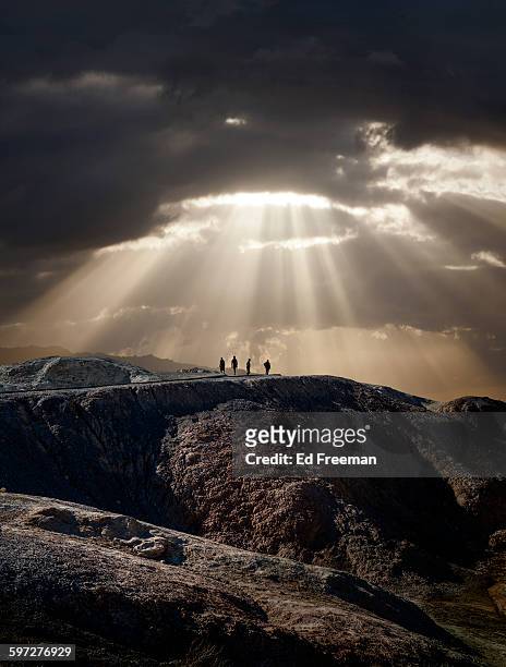 lone figures, mountain, dramatic sky - sunbeam clouds stock pictures, royalty-free photos & images