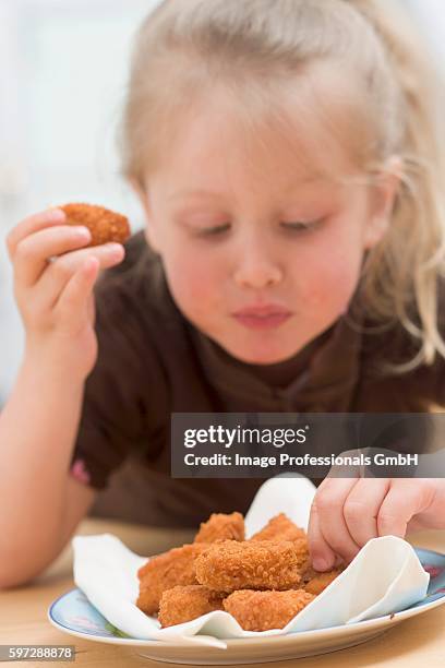 little girl eating chicken nuggets - chicken nuggets ストックフォトと画像