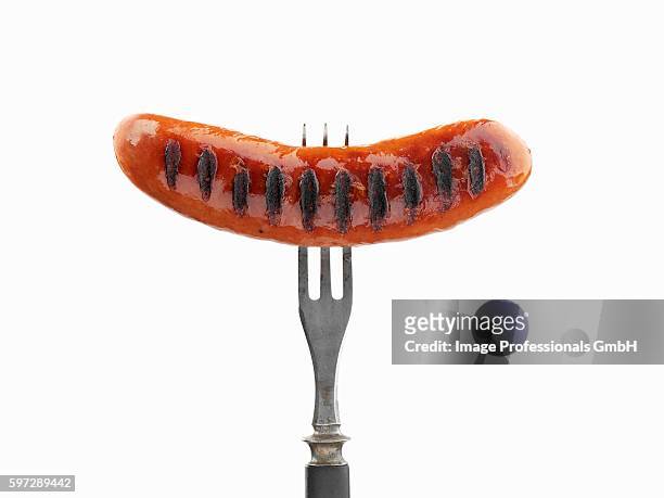 grilled sausage on fork - sausage stock pictures, royalty-free photos & images