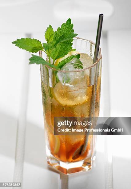 glass of iced tea with lemon slices and lemon balm - lemon balm tea stock pictures, royalty-free photos & images