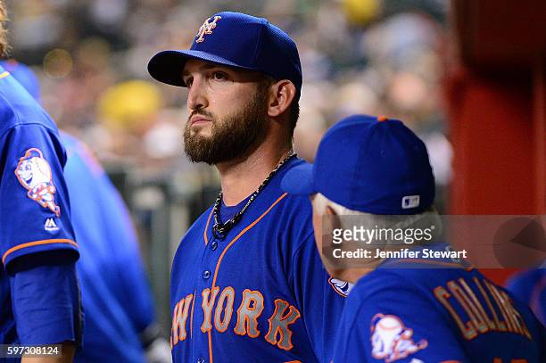 Terry Collins of the New York Mets talks with Jonathon Niese in the dugout after being relieved in the fifth inning of the game against the Arizona...