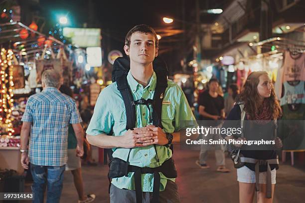 caucasian tourist standing in market at night - chiang mai sunday market stock pictures, royalty-free photos & images