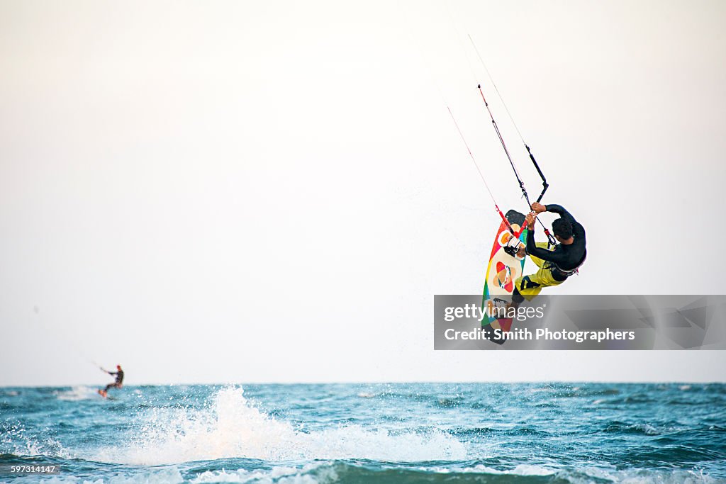 Man kiteboarding over ocean waves