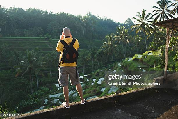 caucasian tourist photographing rural rice terrace, ubud, bali, indonesia - tegallalang stock pictures, royalty-free photos & images