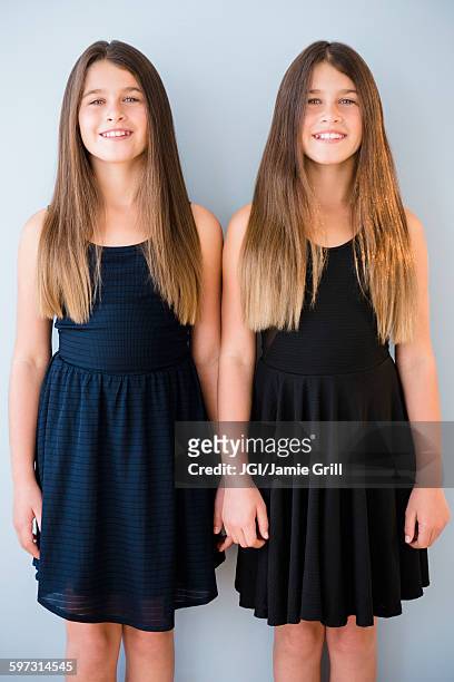 caucasian twin sisters wearing dresses - twin girls bildbanksfoton och bilder