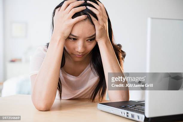 frustrated chinese woman using laptop - asian woman angry stock pictures, royalty-free photos & images