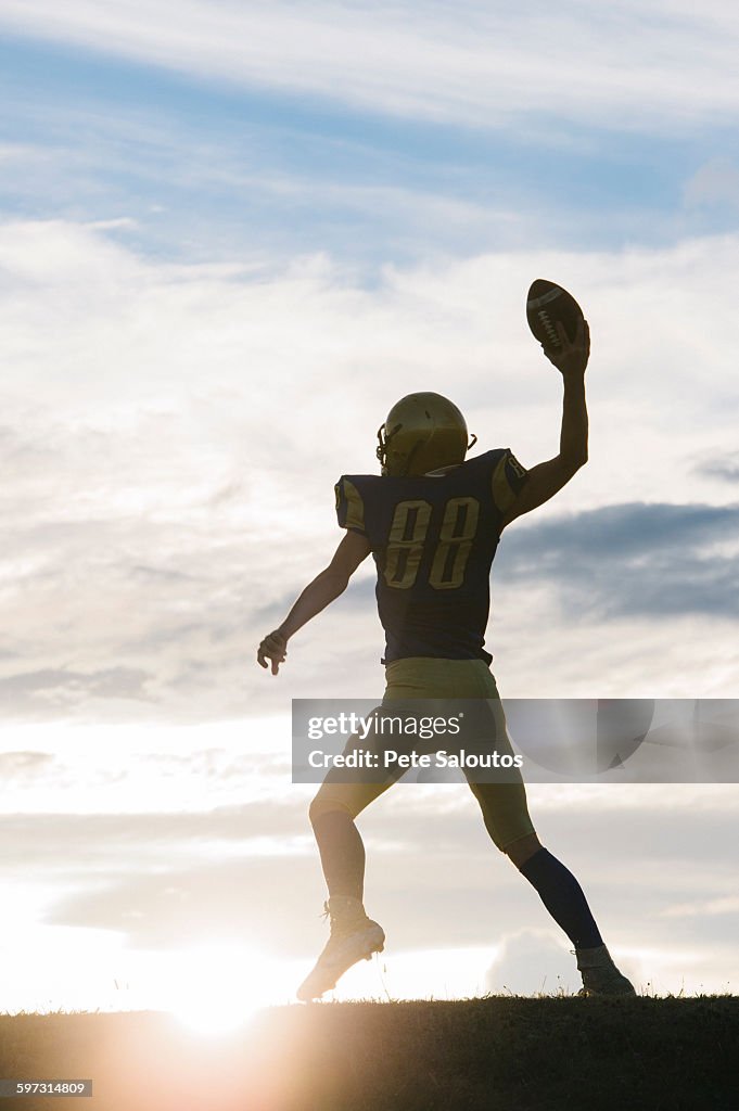 Young american football player about to throw ball