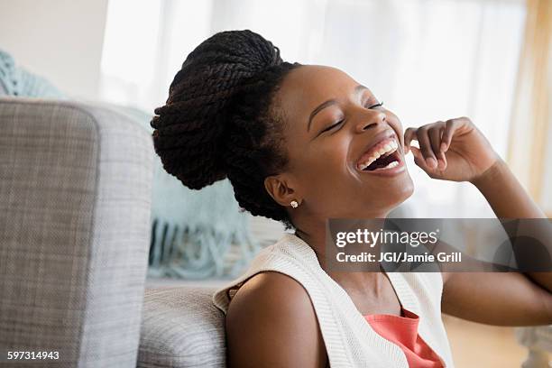 black woman laughing - braided buns stock pictures, royalty-free photos & images