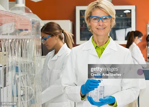 scientist holding beaker in laboratory - vetenskapskvinna bildbanksfoton och bilder