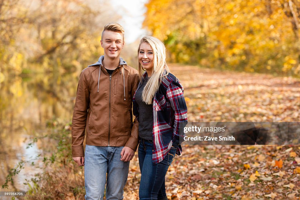 Portrait of teenage boy and adult sister in autumn forest