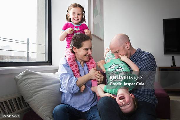 family playing in living room - holding upside down stock pictures, royalty-free photos & images