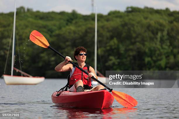 caucasian woman rowing kayak - boston massachusetts summer stock pictures, royalty-free photos & images