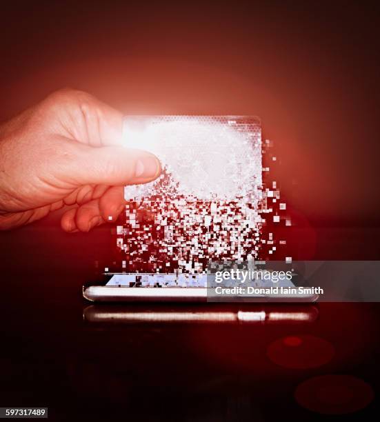 caucasian man holding pixelated credit card - digital payment imagens e fotografias de stock