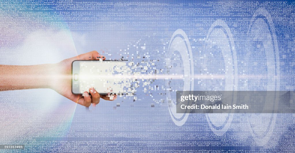Mixed race girl holding transmitting cell phone