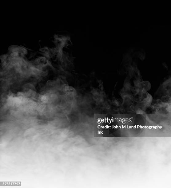 rising steam on black background - nebbia foto e immagini stock