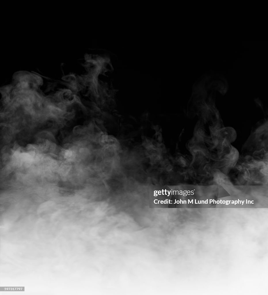 Rising steam on black background