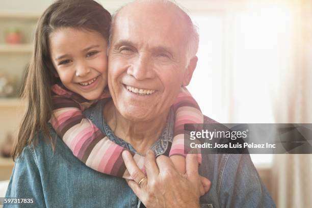 granddaughter hugging grandfather - granddaughter stock pictures, royalty-free photos & images