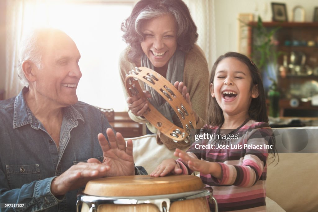 Grandparents and granddaughter playing music together