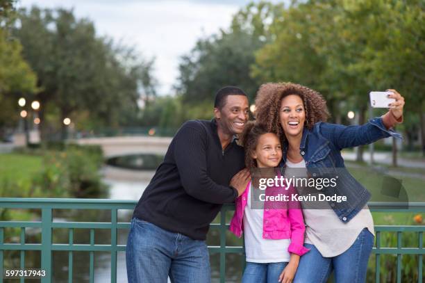 family taking selfie on bridge - orlando florida family stock pictures, royalty-free photos & images