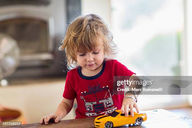 caucasian boy playing with toy car - boy playing with cars stock pictures, royalty-free photos & images