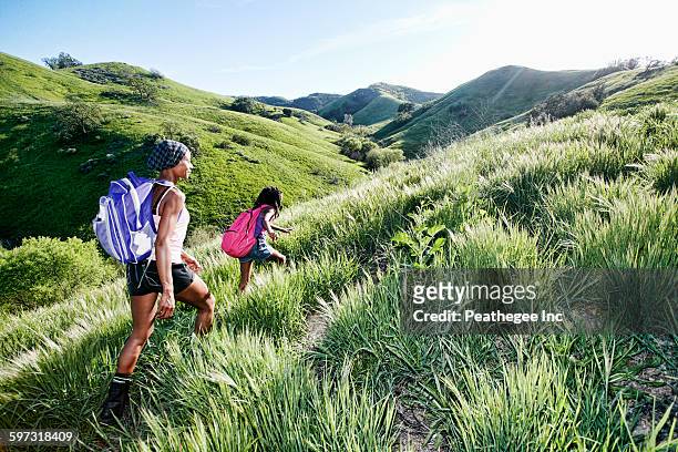 black mother and daughter walking on rural hillside - black hills 個照片及圖片檔