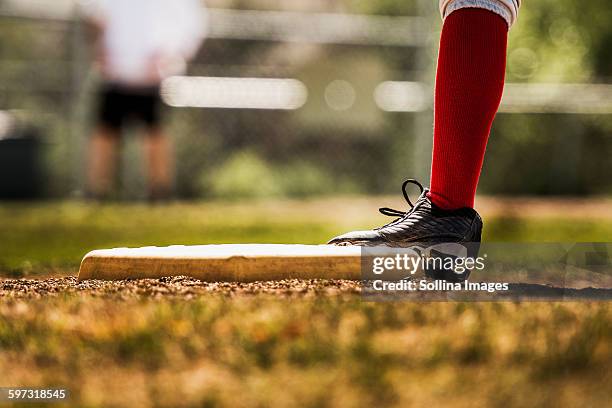 baseball player touching base - base sports equipment fotografías e imágenes de stock