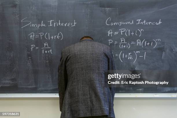 caucasian teacher frustrated at chalkboard - miss stock-fotos und bilder