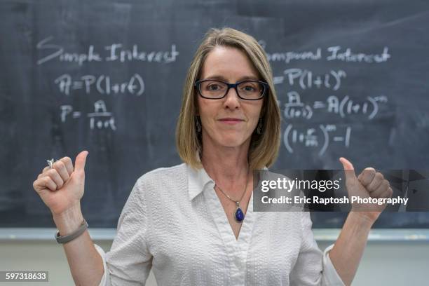 caucasian teacher cheering at chalkboard - female lecturer stock pictures, royalty-free photos & images