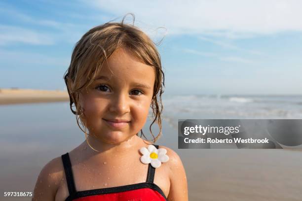 mixed race girl smiling on beach - blonde girl wet hair stock pictures, royalty-free photos & images
