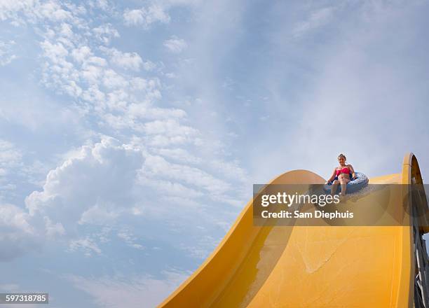 hispanic woman on water slide - water slide stockfoto's en -beelden