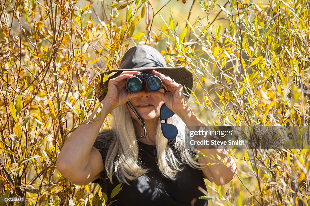 Caucasian woman using binoculars