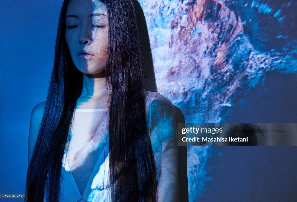 Woman in front of projection with Underwater model