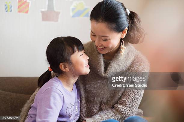 mother and daughter in room,smiling - purple shirt fotografías e imágenes de stock
