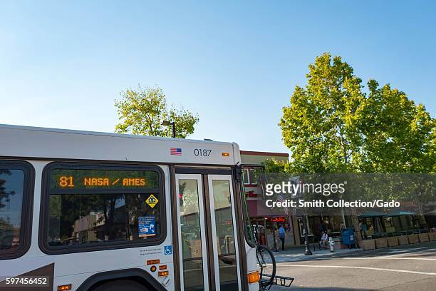 On Castro Street, in the downtown portion of the Silicon Valley town of Mountain View, California, a bus passes by with a sign indicating that it is...