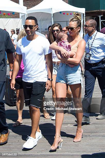 Model Chrissy Teigen and musician John Legend with their baby Luna Simone Stephens attend the 2016 Sports Illustrated Summer of Swim Fan Festival &...