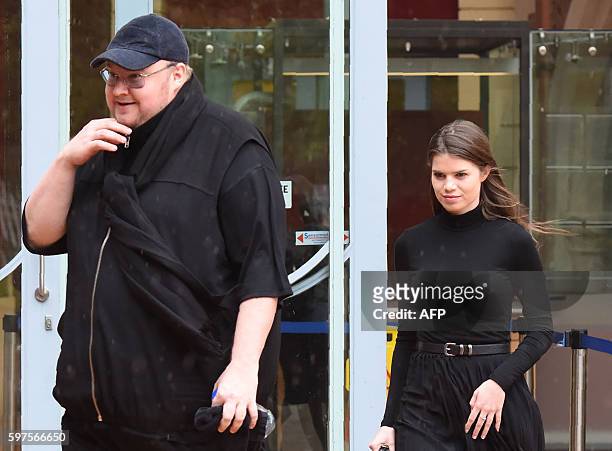 Internet mogul Kim Dotcom leaves with his girlfriend Elizabeth Donelly following his extradition appeal at the High Court in Auckland on August 29,...